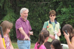 Keith-Hayes, President providing instruction on the planting of a native species